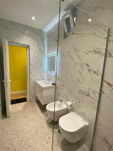 a bathroom with a white toilet and a sink at Tirana Center Apartaments in Tirana +37 photos