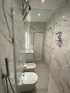 a bathroom with two toilets and a sink at Tirana Center Apartaments in Tirana