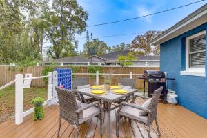 a patio with a table and chairs and a grill at Florida Home Travel NursesandExtended Stays Welcome in St Petersburg