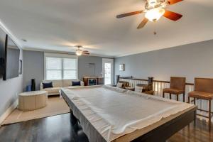 a large bed in a living room with a ceiling fan at NEW 7 mins to Broadway Sleeps 8 in Nashville