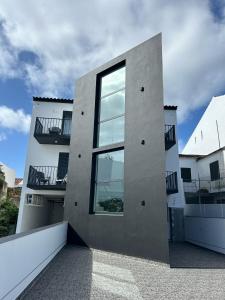 a building with a window on the side of it at The Rock Hostel in Ponta Delgada