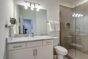 a bathroom with a sink and a toilet and a shower at 10 Percent OFF New Home Downtown Sleeps 8 in Nashville +24 photos