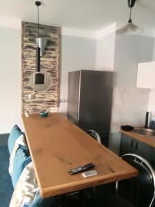 a wooden table with a remote control on top of it at Apartamenty Sielawa in Mikołajki