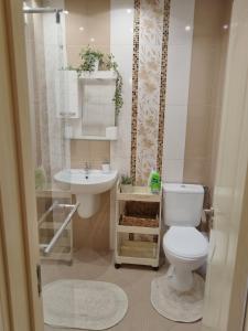 a bathroom with a toilet and a sink at Sweety in Sliven +33 photos