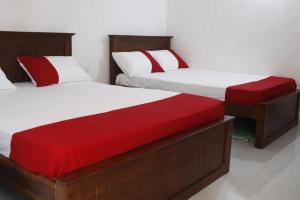 A bed or beds in a room at Serenity Valley Ambuluwawa Resort
