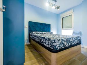 a bedroom with a bed in a blue room at Apartamentos Nirvana y Averno in Águilas