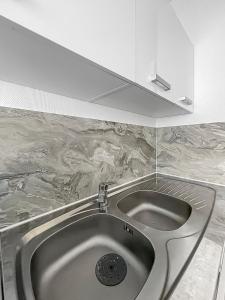 a sink in a kitchen with a counter top at Refuge d'Anjou in Angers
