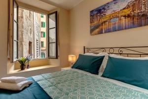 a bedroom with a bed and a painting on the wall at Golden House in Florence