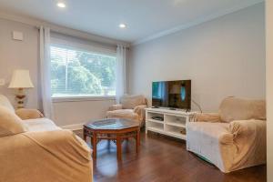 a living room with two chairs and a tv at Private Home 6miles to downtown 4 miles to airport in Nashville