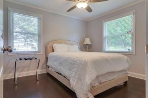 a white bedroom with a bed and two windows at Private Home 6miles to downtown 4 miles to airport in Nashville