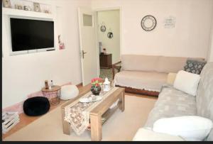 a living room with a couch and a table at Little House in Mouzaki