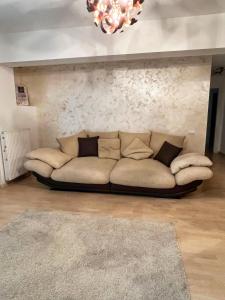 un sofá en una sala de estar con una lámpara de araña en Wonderful Park Residences 5, en Bucarest 20 fotos más