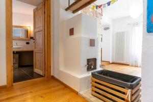 a room with a kitchen with a wall at Alla Contrada, Pergine Valsugana Ospitar in Pergine Valsugana