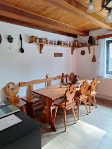 a dining room with a wooden table and chairs at Jirkova chata in Lipova Lazne