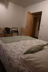 a bedroom with a bed with a pillow on it at Hiša Štekar in Kojsko +25 photos