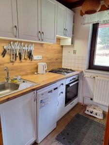 a kitchen with white appliances and a counter top at Jirkova chata in Lipova Lazne