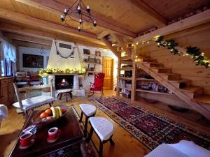 a living room with a staircase and a fireplace at Fireplace Chalet in Žabljak