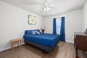 a bedroom with a blue bed and a ceiling fan at Coastal Paradise -community Pool in Rockport +11 photos