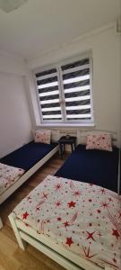 um quarto com 2 camas e 2 janelas em LARA S em Banja Luka