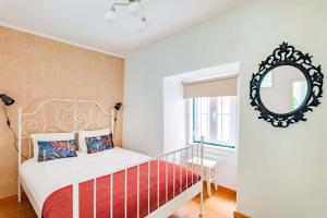 リスボンにあるAlfama Apartmentsのベッドルーム(ベッド1台、鏡付)