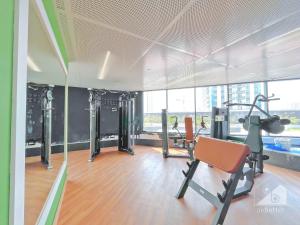 a gym with cardio equipment in a room with windows at NEW!Luxury 1B with balcony in Blue Wave Tower Dubai in Dubai