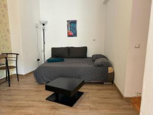 a living room with a couch and a table at Magheru City Center Studio in Bucharest