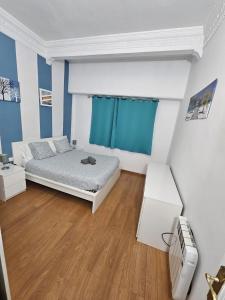 a bedroom with a bed and blue and white walls at Apartamentos Turia in Valencia