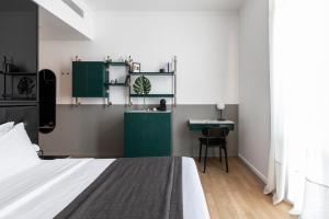 a bedroom with green cabinets and a bed and a desk at The Modernist Thessaloniki in Thessaloniki