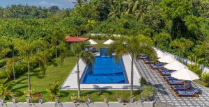 an overhead view of a resort swimming pool with umbrellas and chairs at Hotel Southern Blue Sapphire in Induruwa