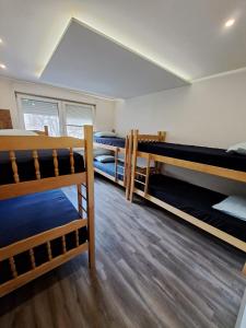 a dorm room with three bunk beds in it at Alpi Hostel in Skopje