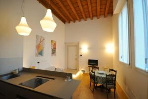 a kitchen and living room with a table and chairs at Domus Padova palazzo Roccabonella in Padova