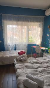 a bedroom with two twin beds and a window at Colombo Holidays APT in Rome