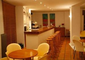 a restaurant with a bar with wooden tables and chairs at Hanioti hotel in Hanioti +16 photos