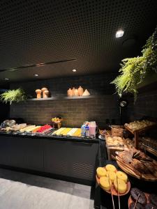 a bakery counter with a lot of different types of food at Fity Hotel in Recife