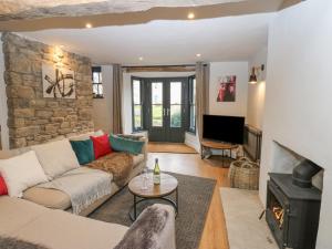 a living room with a couch and a fireplace at 4 Castle Terrace in Barnard Castle