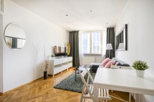 ein Wohnzimmer mit einem Sofa und einem Tisch in der Unterkunft Pańska Residence in Warschau