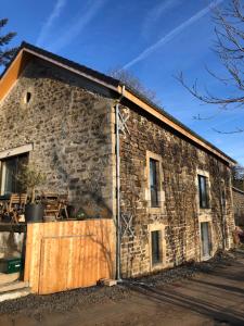 a large stone building with a wooden door at BASALTE in Saint-Front