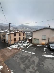 a parking lot with cars parked in front of a building at La Gabare 1 in Thiers