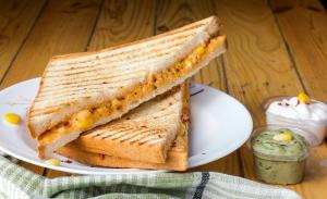a grilled sandwich on a plate on a table at Parvata Droni in Shimla