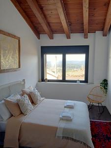 a bedroom with a large bed and a window at CASA RURAL ALEGRE in La Fresneda +1 photo