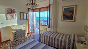 a living room with a bed and a window at Le terrazze sul Lido in Alghero