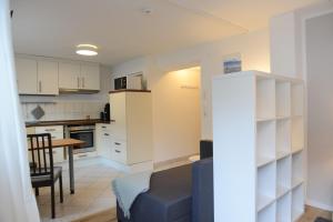 a kitchen and living room with a couch and a table at Ferienwohnung Malou in Tettnang +7 photos