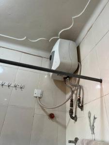 a bathroom with a hair dryer on the wall at MD comfort living in Kampala