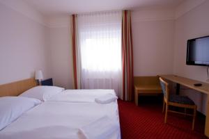 Postel nebo postele na pokoji v ubytování Hotel Jacobsberg