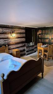 a bedroom with a bed and a wooden wall at Les Petites Bulles de Massier in Vienne