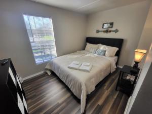 a bedroom with a bed with two towels on it at Green Haven Property in Austin