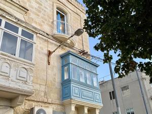 a blue box on the side of a building at Mediterranea Waterfront house - By Valletta Ferry & Free Parking in Cospicua