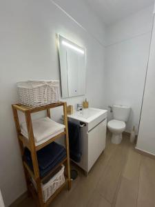 a bathroom with a white sink and a toilet at Brisamar, serenidad frente al mar in Bajamar