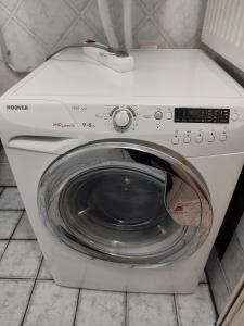 a white washing machine with its door open at Apartments to nature A in Ámmos