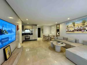 a large living room with a couch and a table at Appart de standing + piscine sur le toit in Marrakech